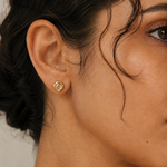 Model wearing the Halo Stud — a round cubic zirconia set in an organic molten-edge 18K gold bezel — Zoé Jewelry.