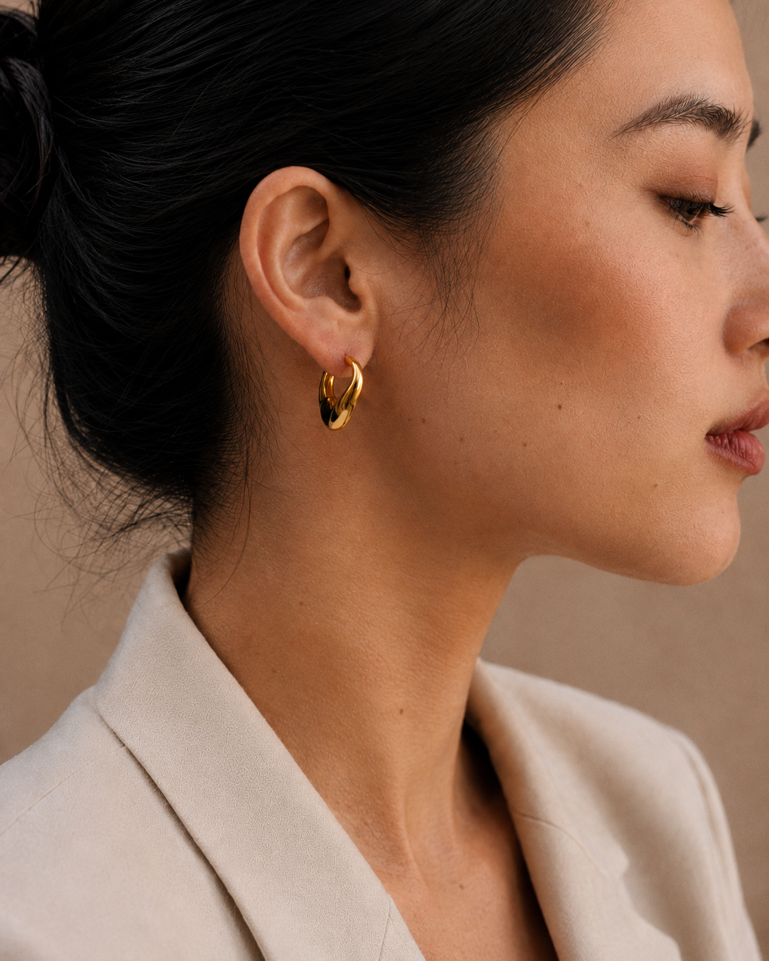  Model wearing the Adele Dome Hoops — chunky 18K gold dome hoops — Zoé Jewelry.