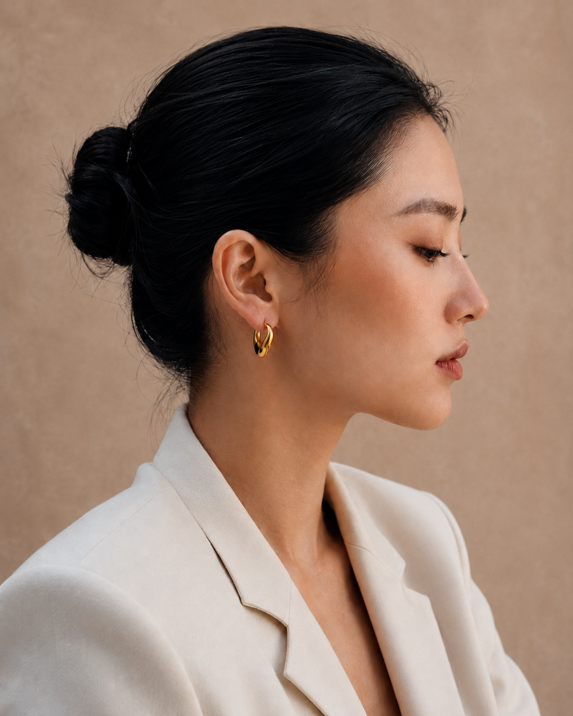  Model wearing the Adele Dome Hoops — chunky 18K gold dome hoops — Zoé Jewelry.