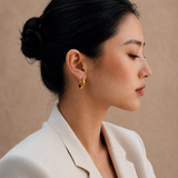  Model wearing the Adele Dome Hoops — chunky 18K gold dome hoops — Zoé Jewelry.