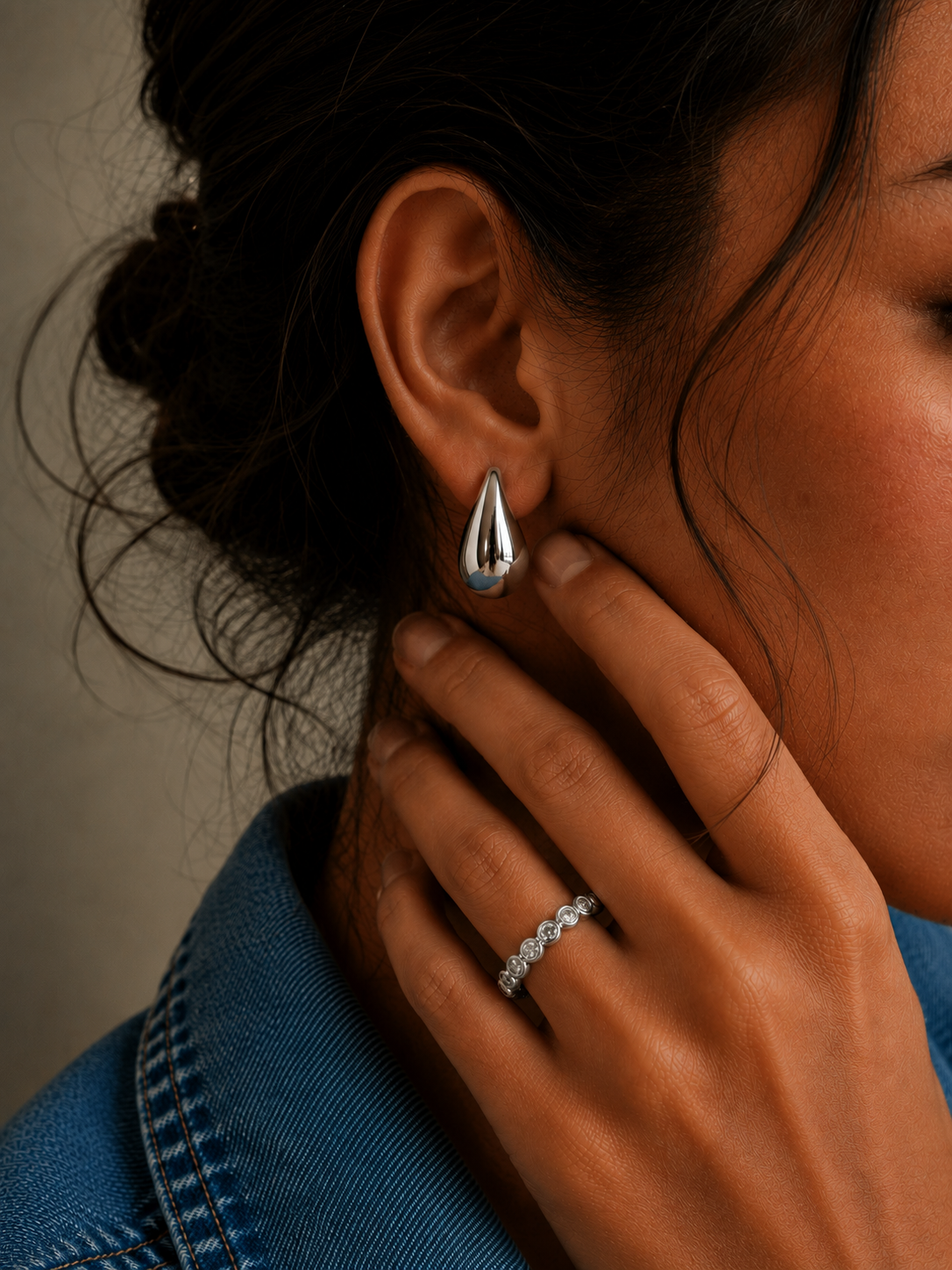 Arden Ring in a silver-tone finish with an emerald-cut cubic zirconia stone in a bezel setting, adjustable ring from Zoé Jewelry.