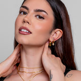 Woman wearing Ava gold huggie earrings, everyday minimalist style