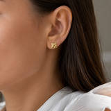 Model wearing the Carré Studs — textured square gold studs with a molten finish — Zoé Jewelry.