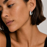 Model wearing the Eden Silver Hoops — chunky rhodium-plated silver teardrop dome hoops — Zoé Jewelry.