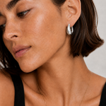 Model wearing the Eden Silver Hoops — chunky rhodium-plated silver teardrop dome hoops — Zoé Jewelry.