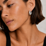 Model wearing the Eden Silver Hoops — chunky rhodium-plated silver teardrop dome hoops — Zoé Jewelry.