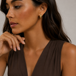 Model wearing the Echo Hoops — chunky ribbed gold hoops — Zoé Jewelry.