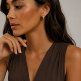 Model wearing the Echo Hoops — chunky ribbed gold hoops — Zoé Jewelry.