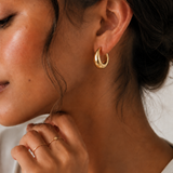  Model wearing the Eden Earrings — chunky gold dome hoops — Zoé Jewelry.