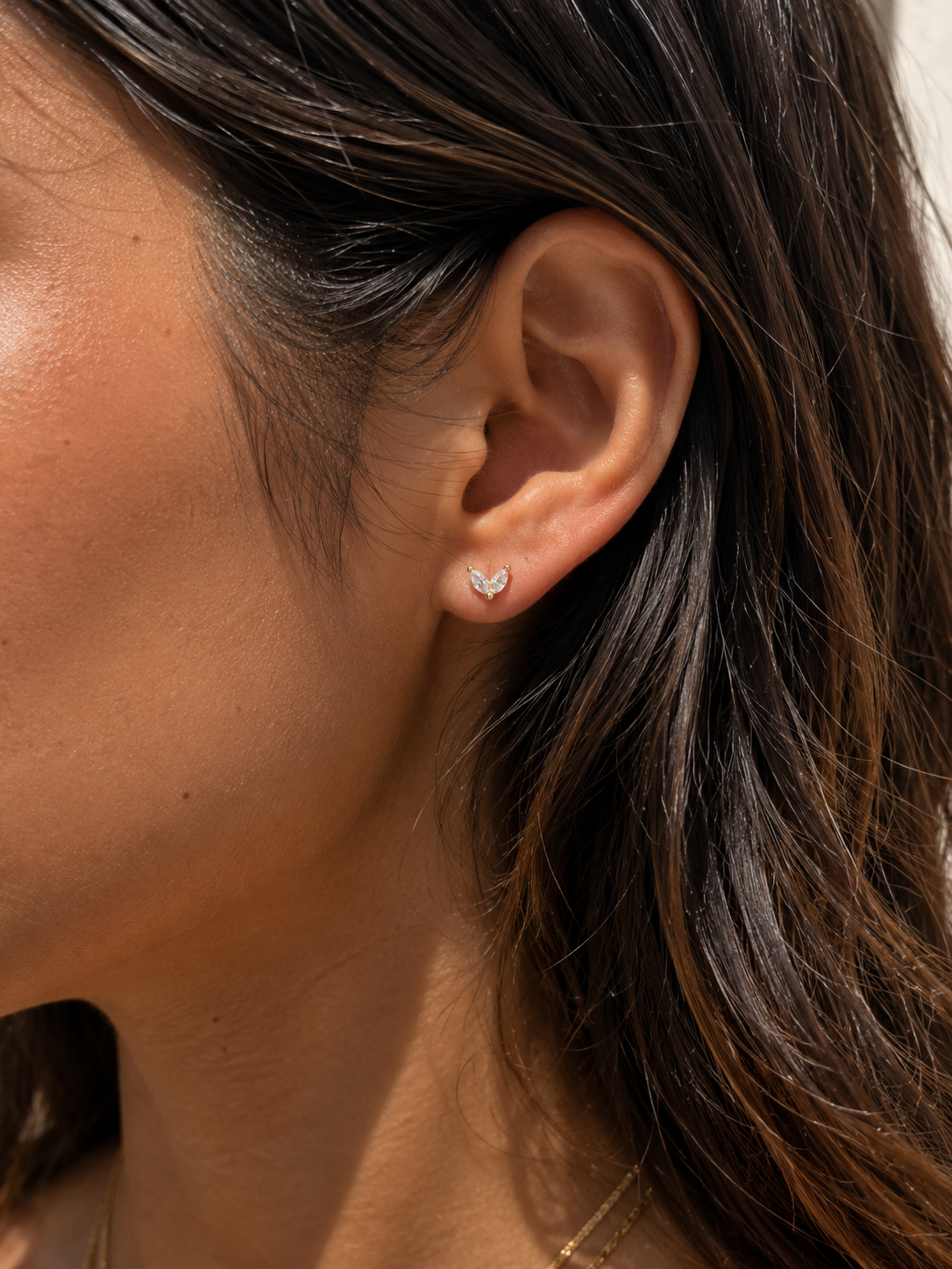Model wearing the Ember Studs — dainty gold petal studs with two marquise-cut cubic zirconia — Zoé Jewelry.