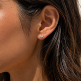 Model wearing the Ember Studs — dainty gold petal studs with two marquise-cut cubic zirconia — Zoé Jewelry.