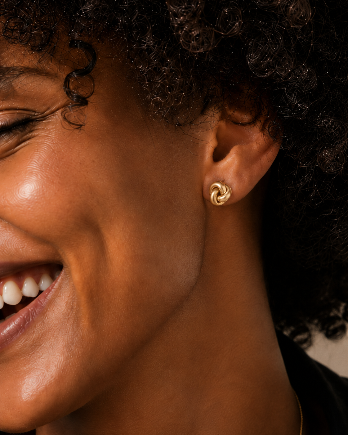 Model wearing the Eternal Knot Studs — dainty gold love-knot stud earrings — Zoé Jewelry.
