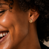 Model wearing the Eternal Knot Studs — dainty gold love-knot stud earrings — Zoé Jewelry.
