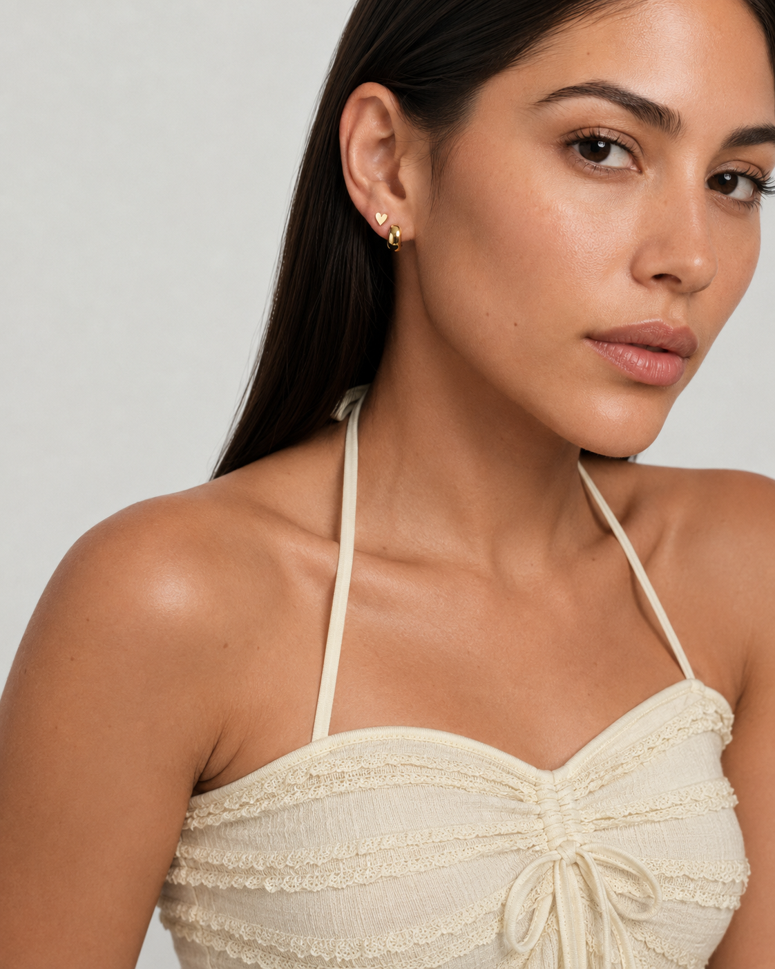 Model wearing the Heart Studs — dainty gold heart stud earrings — Zoé Jewelry.