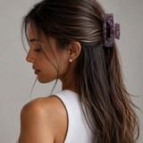 Model wearing the Victoria Large Clip in Lavender Latte holding a half-up twist — a large lavender and latte marbled acetate claw clip from Zoé Jewelry.