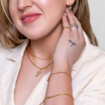 Model wearing Margot paperclip chain necklace in 18K gold-plated finish at the collarbone
