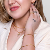 Model wearing Margot paperclip chain necklace in 18K gold-plated finish at the collarbone