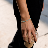Model wearing the Marisol Bracelet — dainty natural green gemstone beads on an 18K gold-plated chain — Zoé Jewelry.

