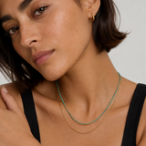 Model wearing the Marisol natural green gemstone necklace layered with a gold paperclip chain — Zoé Jewelry.