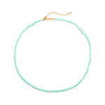 Marisol Necklace laid flat — a dainty strand of faceted natural green gemstone beads on an 18K gold-plated adjustable chain with a Zoé bar tag, from Zoé Jewelry.