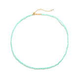 Marisol Necklace laid flat — a dainty strand of faceted natural green gemstone beads on an 18K gold-plated adjustable chain with a Zoé bar tag, from Zoé Jewelry.