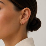 Model wearing the Noelle Hoops — small gold huggie hoops with multicoloured CZ stones — Zoé Jewelry.