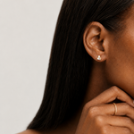Model wearing the Odette Stud — a gold stud pairing a button pearl with a baguette-cut cubic zirconia — Zoé Jewelry.