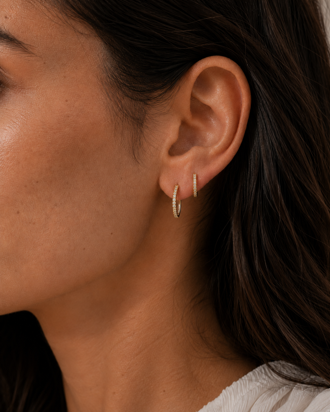 Model wearing the Orbit Hoops — slim gold pavé CZ huggie hoops — Zoé Jewelry.