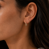 Model wearing the Orbit Hoops — slim gold pavé CZ huggie hoops — Zoé Jewelry.