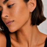 Model wearing the Saddle Up Studs — a tiny 18K gold horseshoe stud with pavé CZ — Zoé Jewelry.