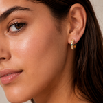 Model wearing the Stardust Hoops with the engraved star side facing out — reversible 18K gold hoops from Zoé Jewelry.