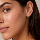 Model wearing the Stardust Hoops with the jewel-toned stone side facing out — reversible 18K gold hoops from Zoé Jewelry.