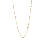 Stellar CZ station necklace with seven bezel-set stones on a beaded gold chain