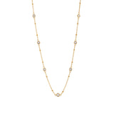 Stellar CZ station necklace with seven bezel-set stones on a beaded gold chain