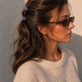  Model wearing two Thea Mini Clips in Cloud in a half-up style — soft blue-grey marbled acetate claw clips from Zoé Jewelry.