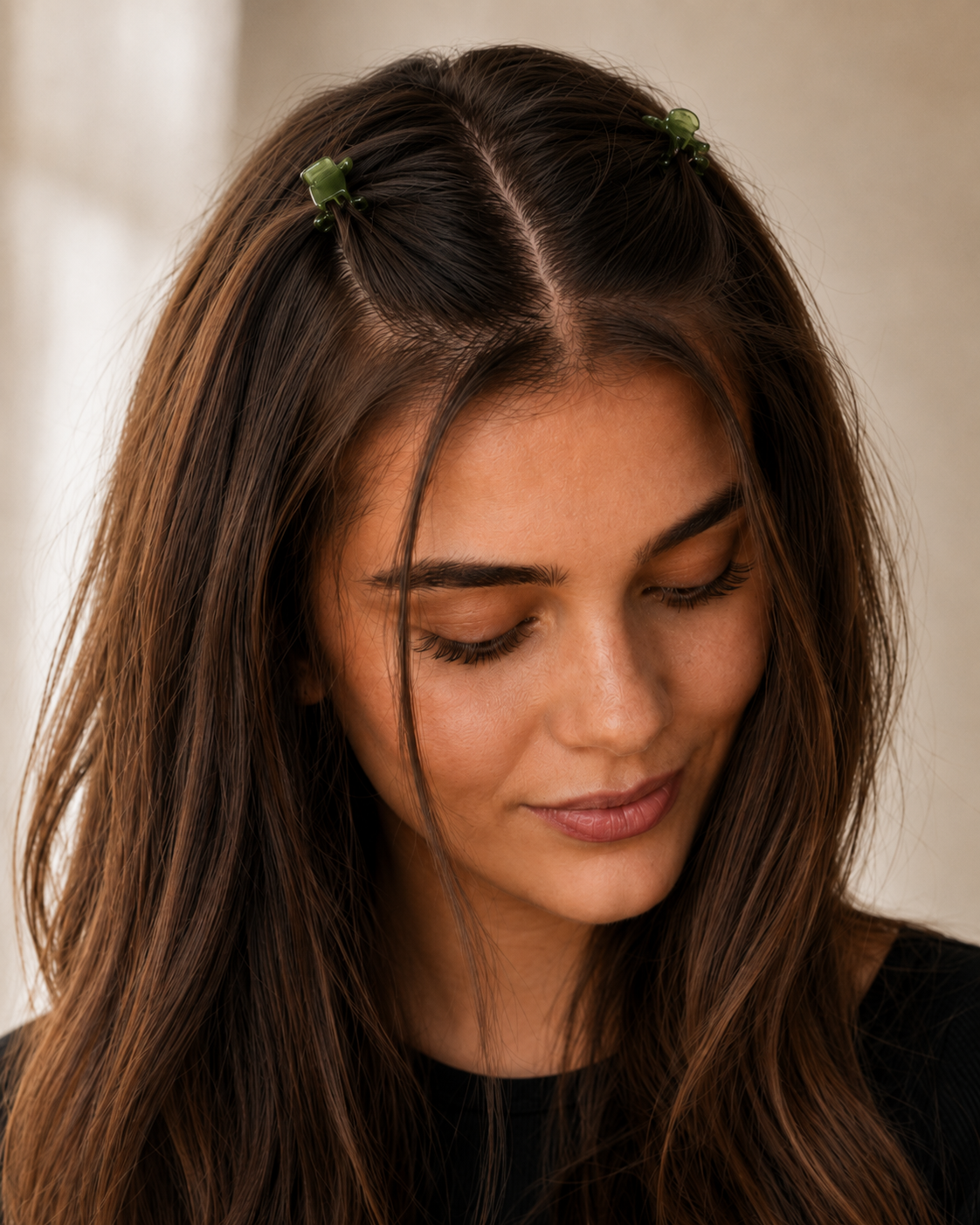 Model wearing two Thea Mini Clips in Matcha twisted into a half-up style — soft green marbled acetate claw clips from Zoé Jewelry.
