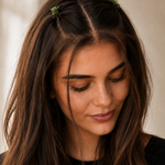 Model wearing two Thea Mini Clips in Matcha twisted into a half-up style — soft green marbled acetate claw clips from Zoé Jewelry.