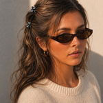  Model wearing two Thea Mini Clips in Monochrome Marble in a half-up style — black and white marbled acetate claw clips from Zoé Jewelry.