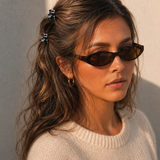 Model wearing two Thea Mini Clips in Monochrome Marble in a half-up style — black and white marbled acetate claw clips from Zoé Jewelry.
