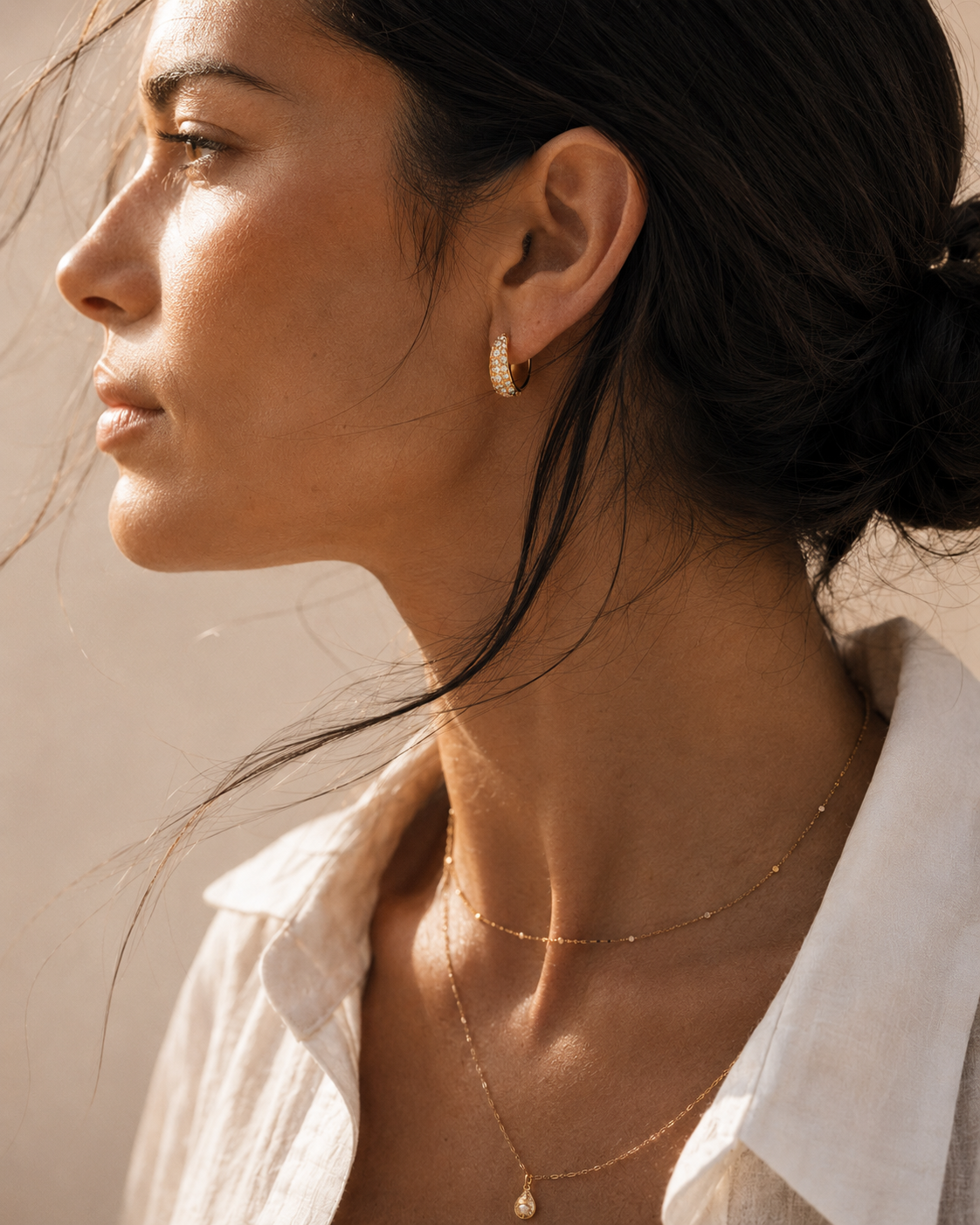 Model wearing the Vera Huggies — domed pavé CZ huggie hoops in 18K gold — Zoé Jewelry.