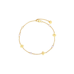 Dainty gold chain bracelet with four-petal flower stations and pearl accents, lobster clasp, adjustable extender, and Zoé disc tag, in 18k gold plating.