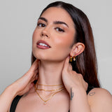 Model wearing a gold paperclip chain necklace, in 18k gold plating.