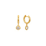 Gold huggie hoop earrings with a round clear cubic zirconia solitaire drop, in 18k gold plating.
