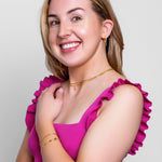 Model wearing a delicate fine gold paperclip chain bracelet on the wrist, in 18k gold plating, soft natural light.