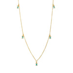 Dainty gold fine chain necklace with green cubic zirconia baguette drops at intervals, in 18k gold plating.