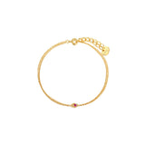 Dainty double gold chain bracelet with a pink cubic zirconia heart detail, spring-ring clasp, adjustable extender, and Zoé disc tag, 18k gold plating.