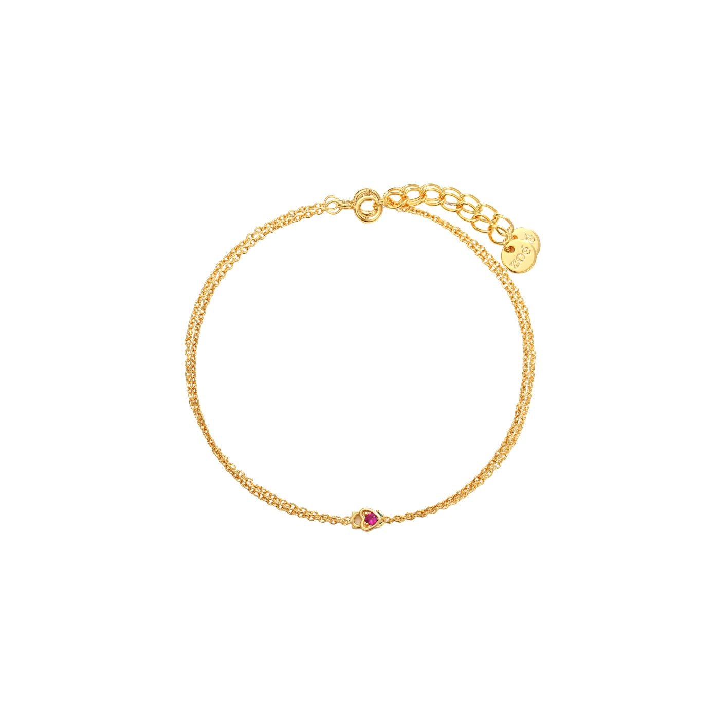 Dainty double gold chain bracelet with a pink cubic zirconia heart detail, spring-ring clasp, adjustable extender, and Zoé disc tag, 18k gold plating.