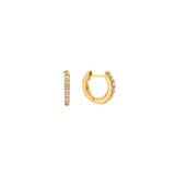 Gold pavé cubic zirconia huggie hoop earrings with a hinged closure, in 18k gold plating.