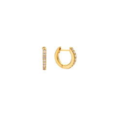 Gold pavé cubic zirconia huggie hoop earrings with a hinged closure, in 18k gold plating.