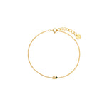 Dainty gold cable chain bracelet with a clear and green cubic zirconia two-stone detail, spring-ring clasp, adjustable extender, and Zoé disc tag, 18k gold plating.